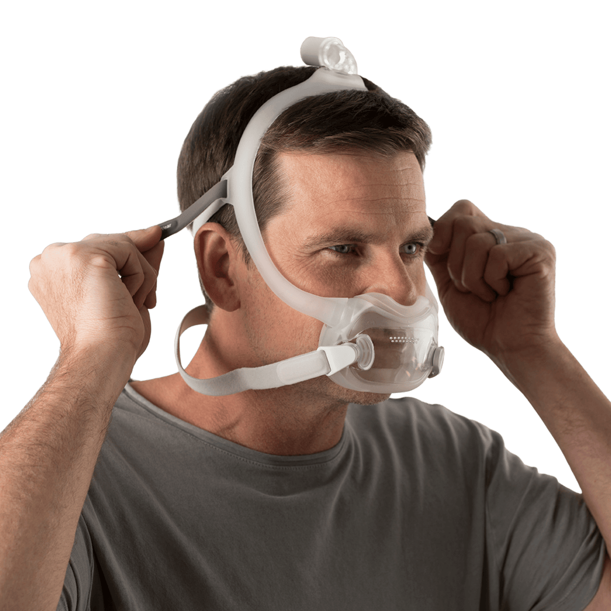 man adjusting the fit tabs on the upper headgear of the dreamwear full face mask