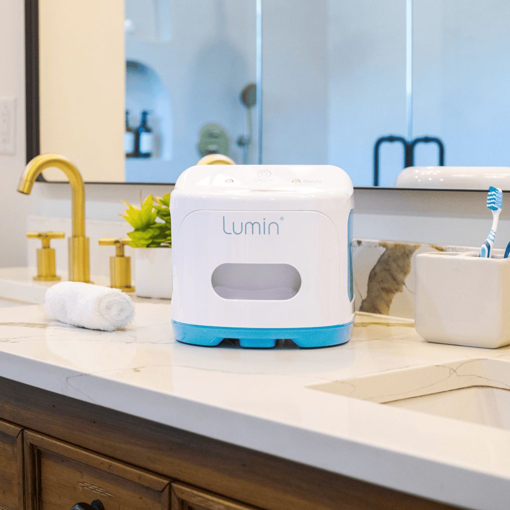 lumin sanitizer sitting on a clean, well-lit bathroom counter.