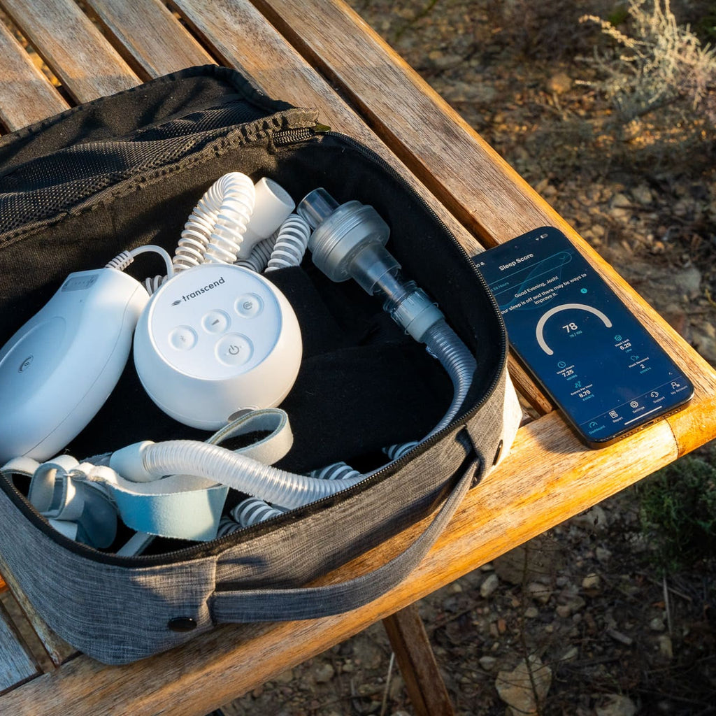 Smiling woman placing transcend micro travel cpap into large purse